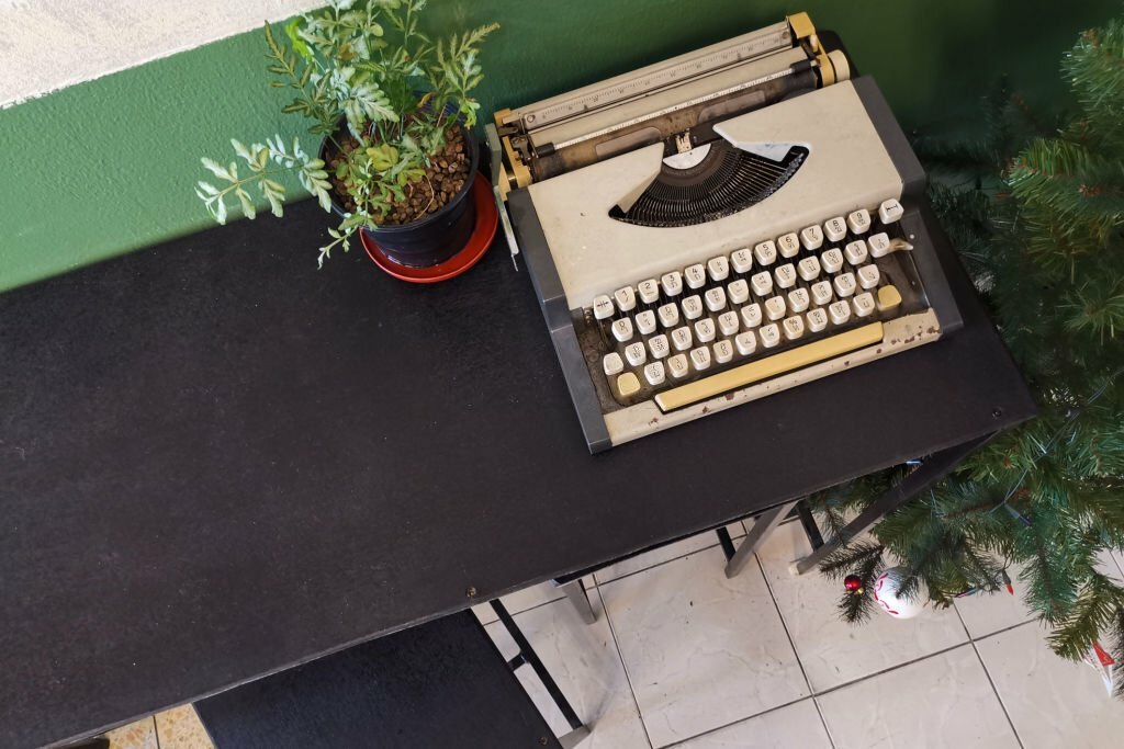 Vintage retro classic typewriter in cafe against wooden table